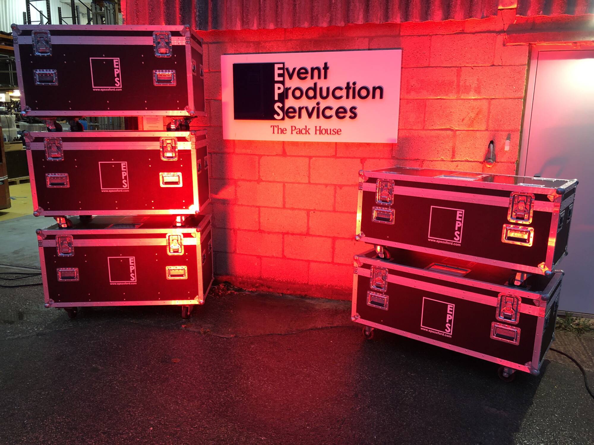 Flightcases outside EPS Headquarters, lit in red